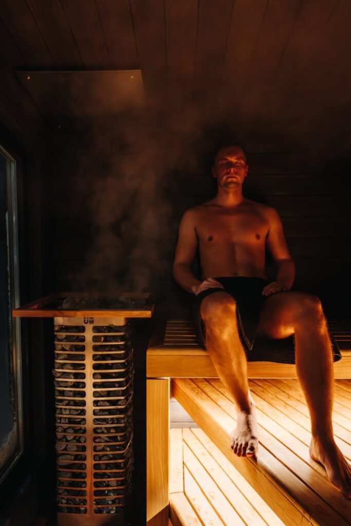 Man enjoying relaxing moment in a steamy Nordic sauna for wellness.